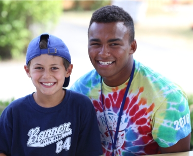 Camper smiling with a counselor