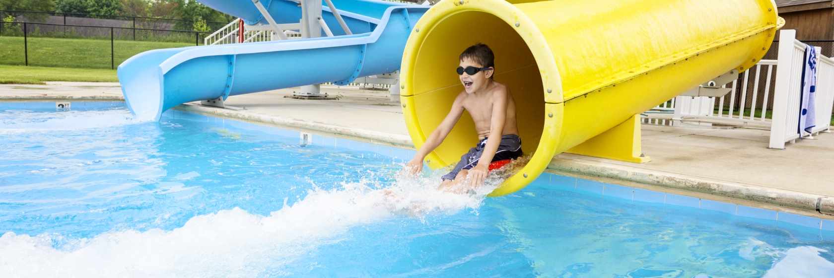 Camper sliding down a water slide