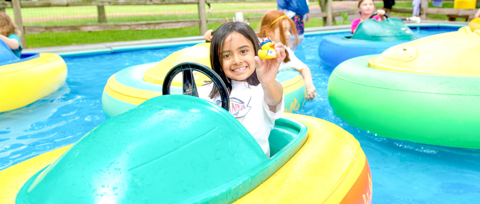 Girl camper in a bumper boat