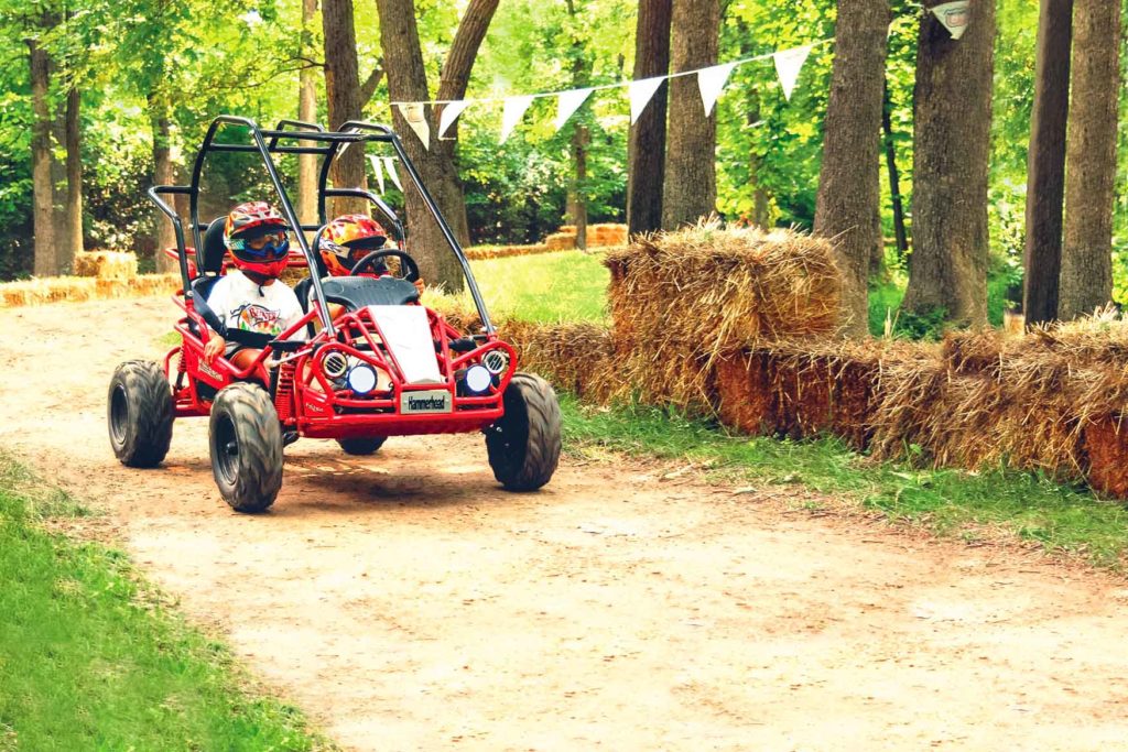 Two people in a red dune buggy