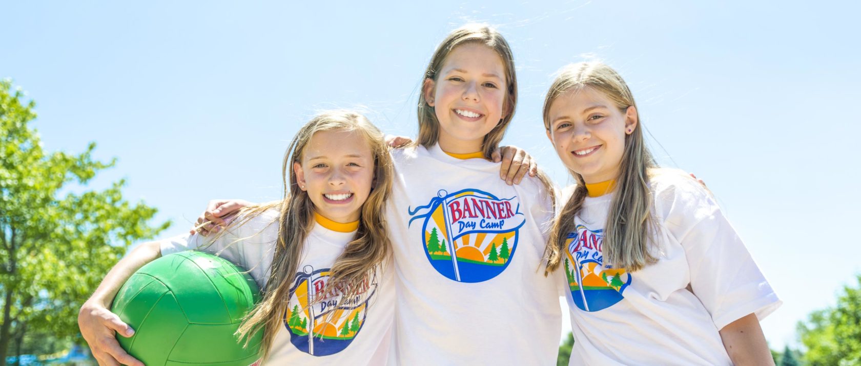 Three girl campers playing volleyball