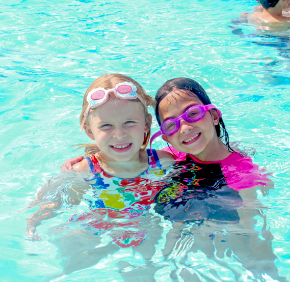 Two girl campers in the pool together