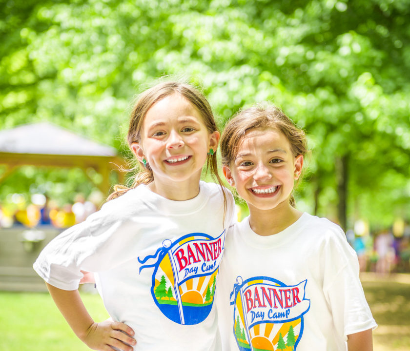 Two girl campers smiling together