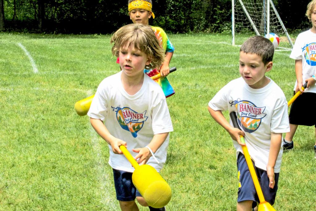 A group of young campers learning how to play lacrosse