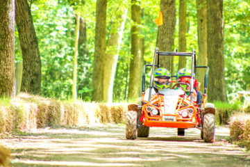 Campers driving a go-kart on the track