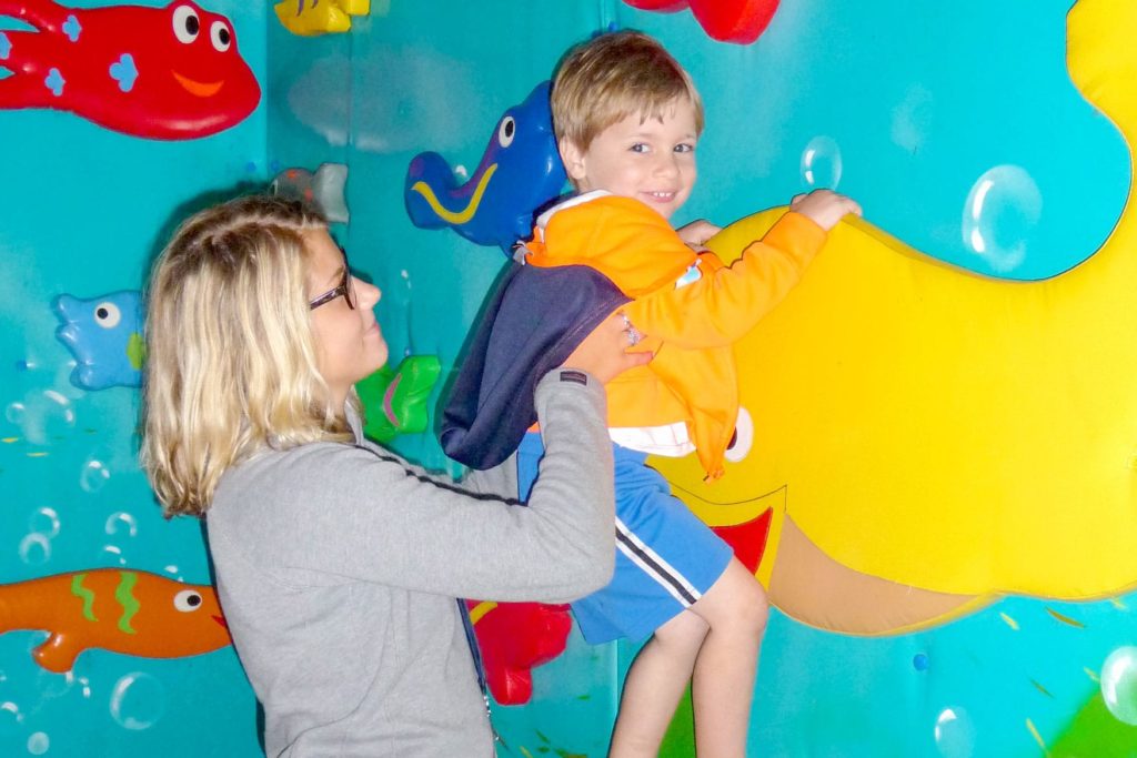 A counselor hoisting a 'super camper' to fly