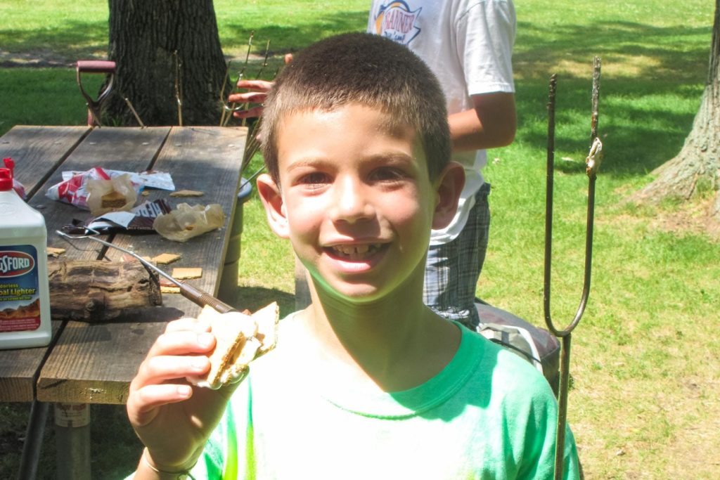 a boy holding a smore