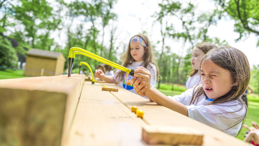 Girl camper shooting a sling shot