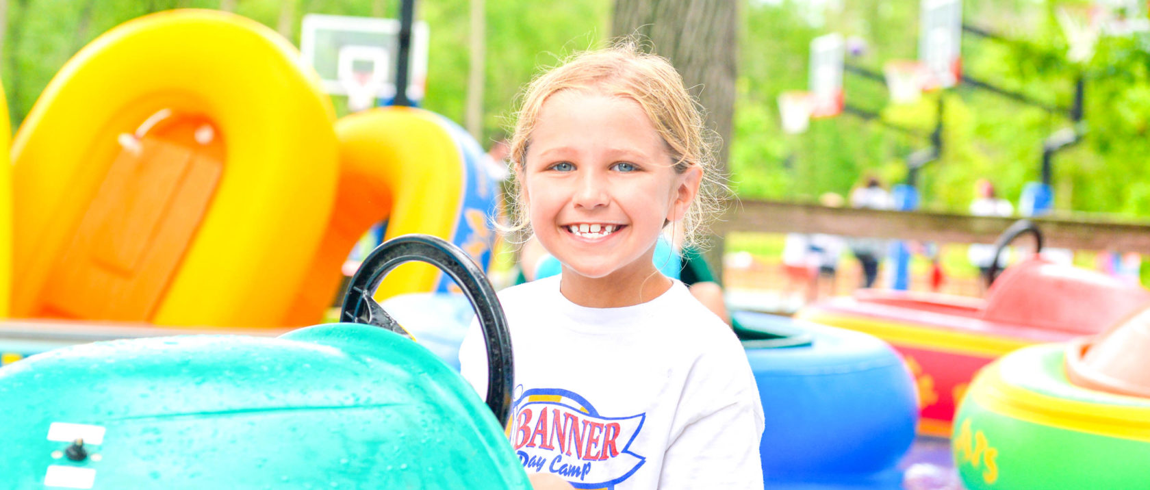 Girl camper smiling on a bumper boat