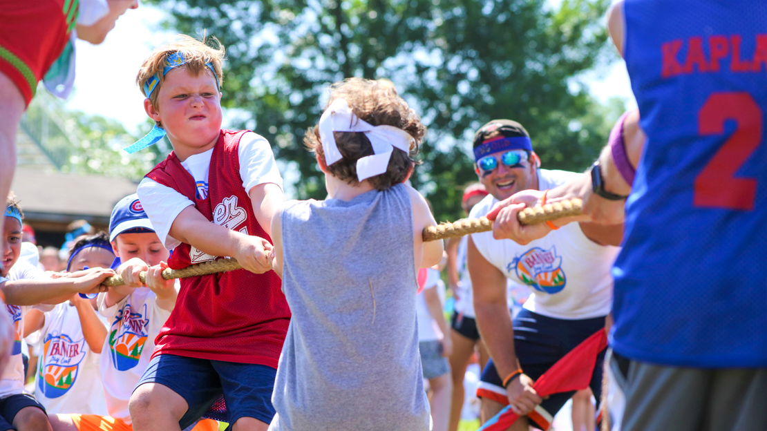 Two boy campers playing tug-o-war