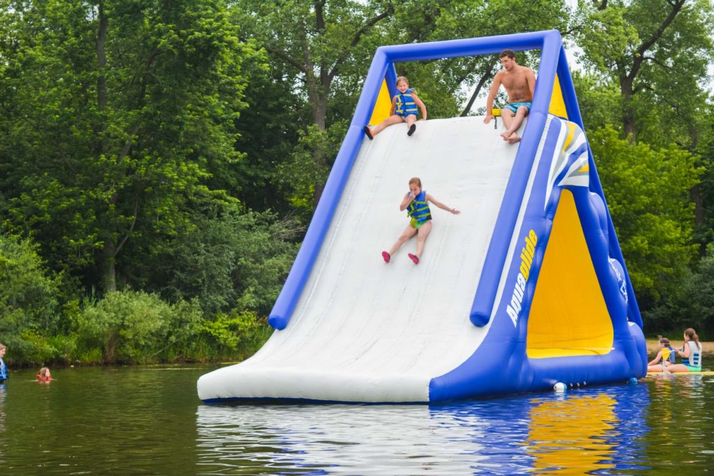 a camper sliding down the bouncy slide