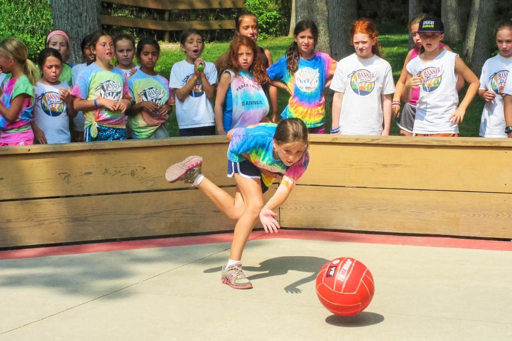 a girl playing handball with a crowd