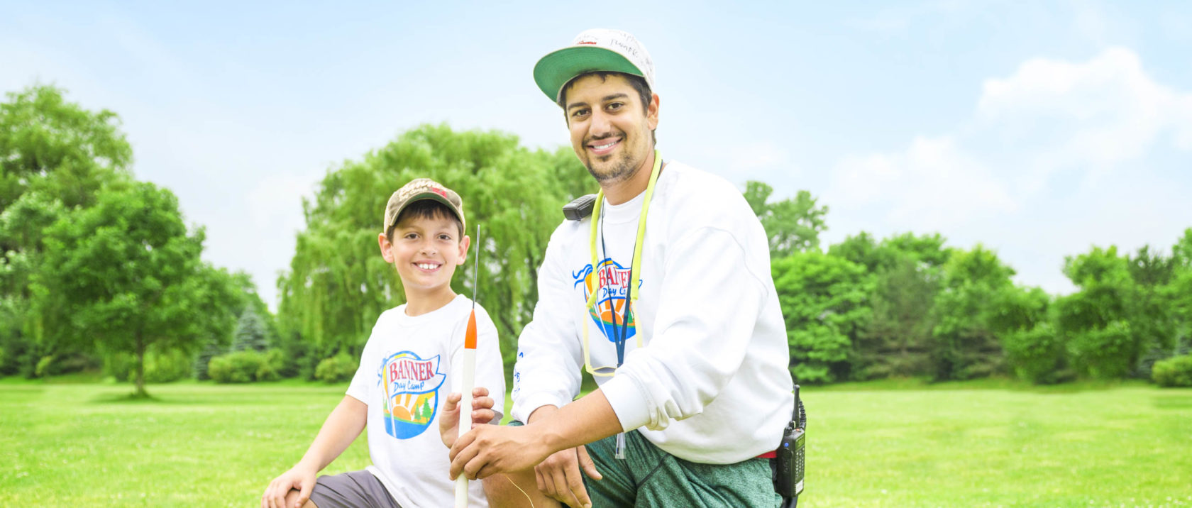 Male staff member helping a boy camper with a rocket launch