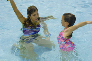 staff teaching swimming lesson