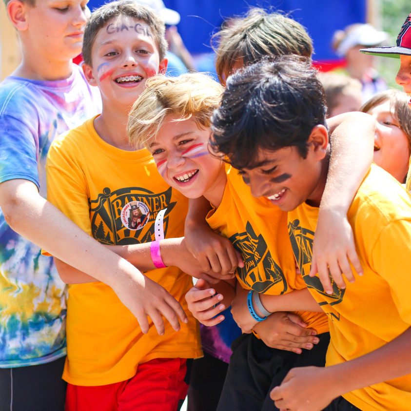 Three boy campers smiling and laughing together