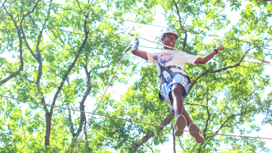 Boy camper walking the ropes course