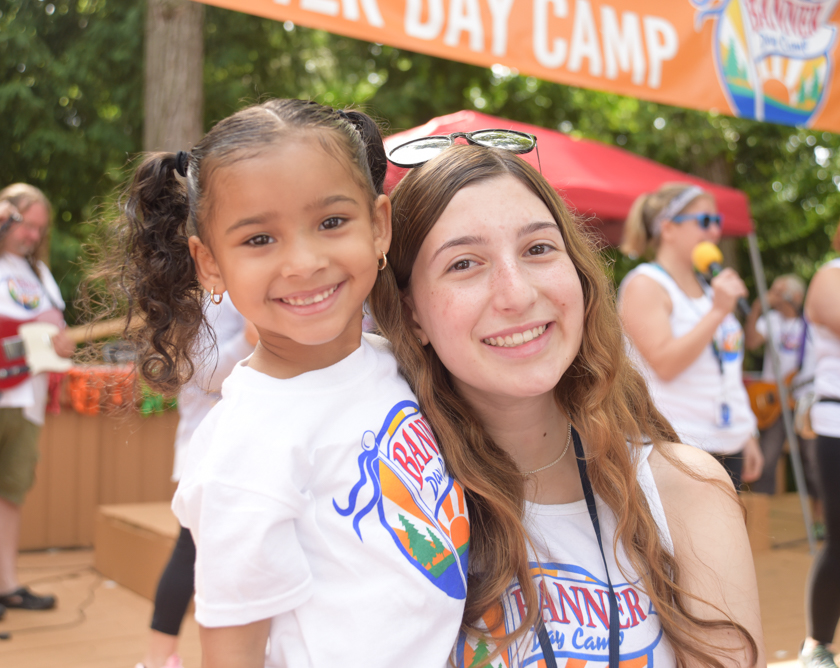 Young girl camper smiling with a female CIT