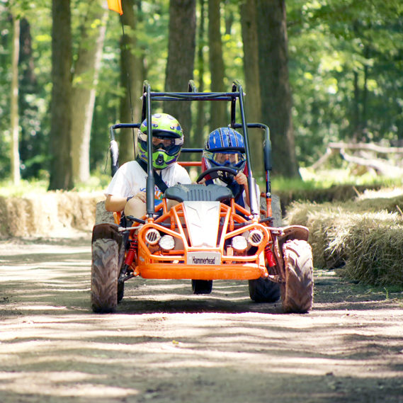 Campers driving a go-kart on the track