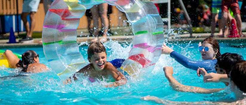 Campers swimming in the pool having fun