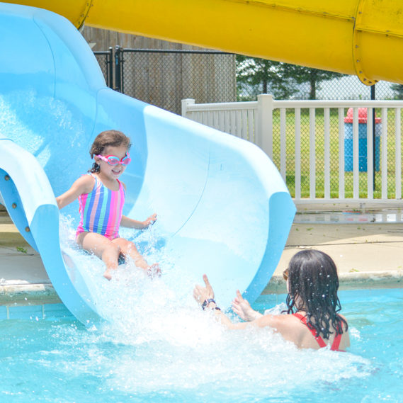 Camper sliding down a waterslide