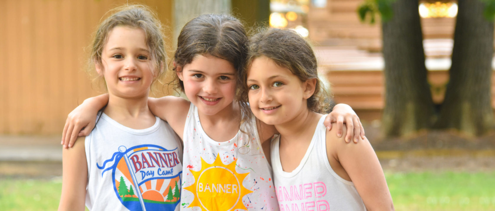 Three female campers pose for a photo