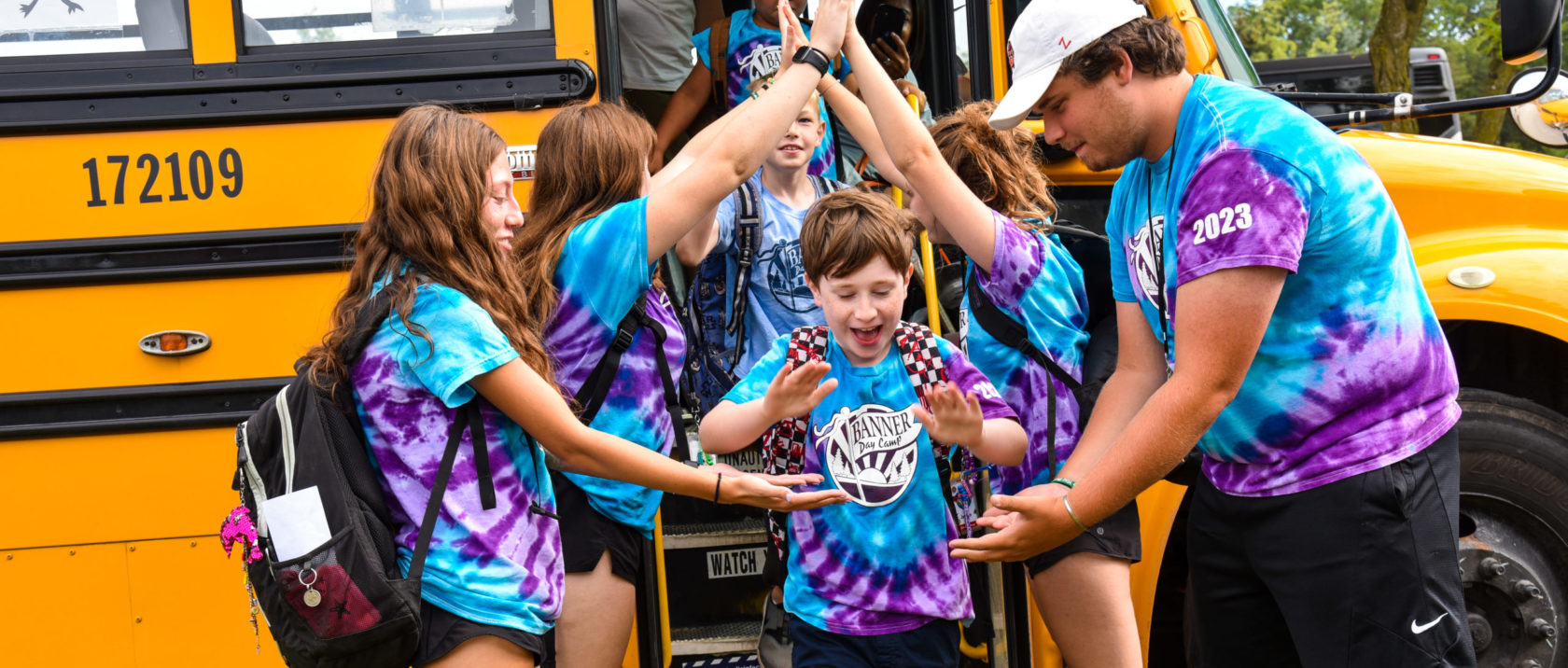 Staff help campers get off the bus