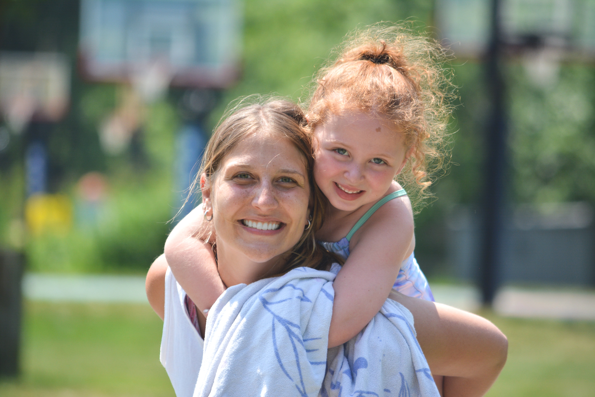 Leadership Team member gives a piggy back ride to a camper